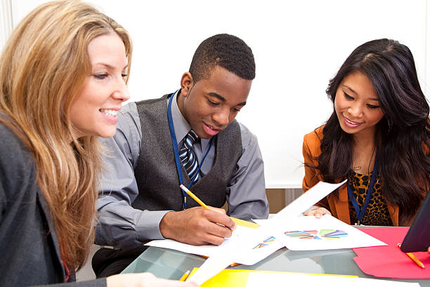 istock Business team discussing marketing strategy by studying charts and graphs 185084942