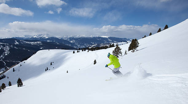Young male skiing at speed on slopes, Vail, Colorado, USA stock photo