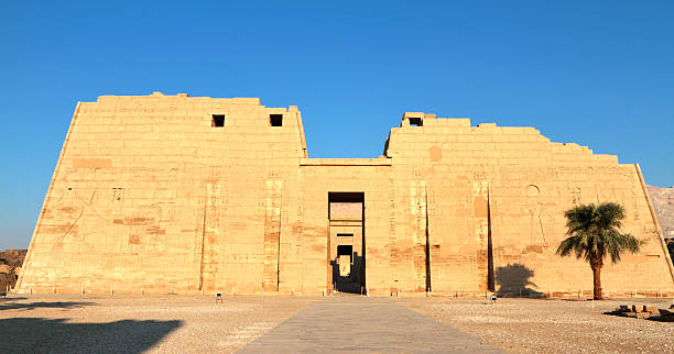 First Pylon, Medinet Habu, Theban Necropolis, Luxor, Egypt "The first pylon of Medinet Habu, the mortuary temple of the 12th century BC pharaoh Ramesses III (also Ramses, Rameses and Usermaatre-meryamun).  Located on the West Bank in the southern part of the Theban necropolis, Medinet Habu is one of the finest temples in Egypt." medinet habu stock pictures, royalty-free photos & images