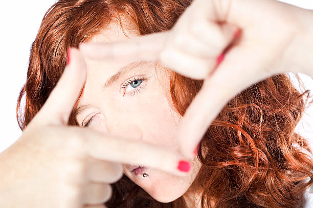 Framing Close-up of beautiful redhead woman framing with fingers. determination focus the bigger picture human hand stock pictures, royalty-free photos & images