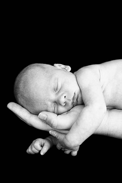 istock Newborn Sleeping in Mother's Hand 185086765