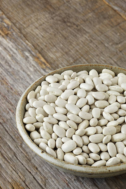 istock Bowl of dried cannellini beans on rustic wood surface 185087700