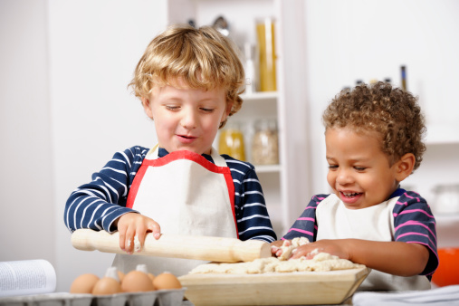 A portrait showing toddlers/ preschoolers enjoyng home baking.