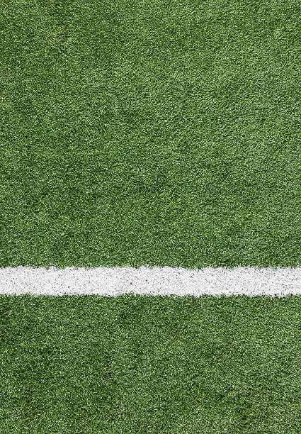 A close-up of a white line on a soccer field stock photo