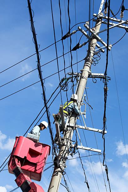 istock Electricians repair a power line 185088398