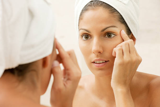 istock Beauty checking her skin in Mirror, looking for Wrinkles (XXXL) 185088427
