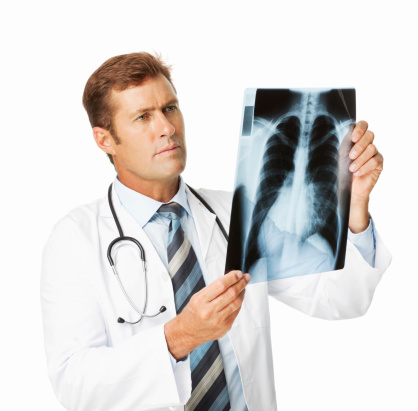 Mid adult male radiologist analyzing lung X-Ray. Square shot. Isolated on white.