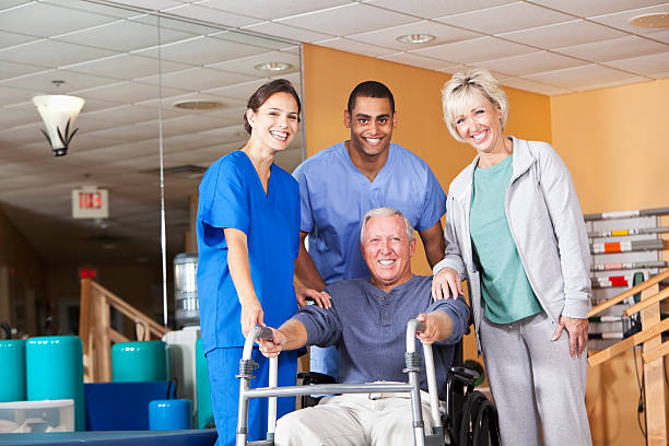 istock Physical therapists with patient and spouse 185088945