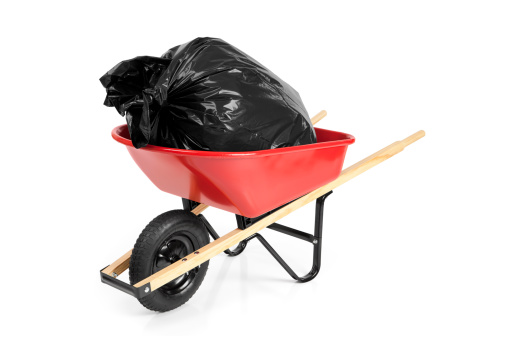 Red wheelbarrow with a trash bag inside. Isolated on white.Please also see: