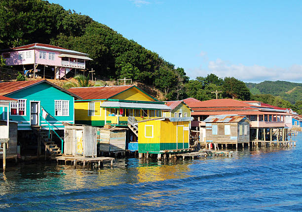 Houses on the coast of Roatan, Honduras "Houses built in stilts along the coast of Roatan, Honduras." honduras stock pictures, royalty-free photos & images