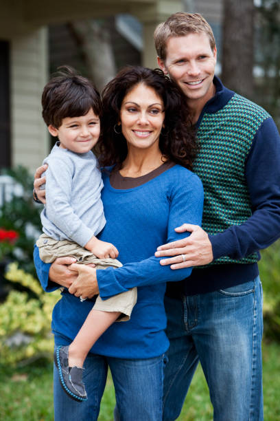 istock Family standing in front of house 185089389