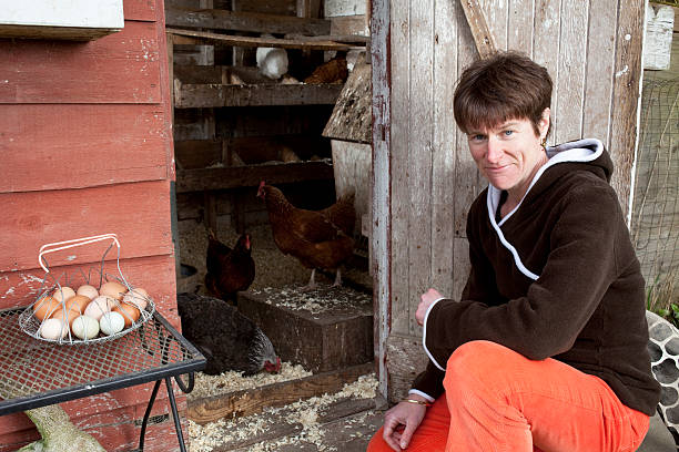 istock Woman with her chickens and eggs. 185089444
