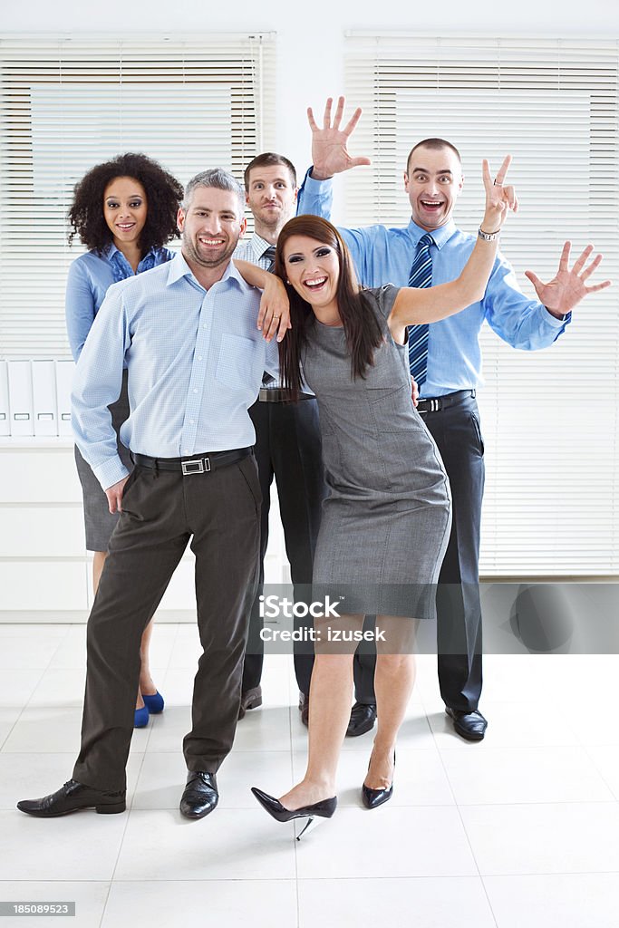 Happy Business Team Portrait of five business people standing in an office and smiling at camera. 25-29 Years Stock Photo