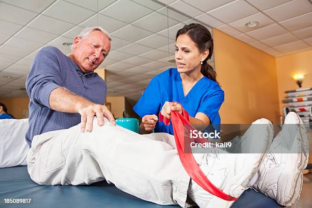 Physical Therapist Working With Patient Stock Photo - Download Image Now - 20-29 Years, 60-69 Years, Active Lifestyle