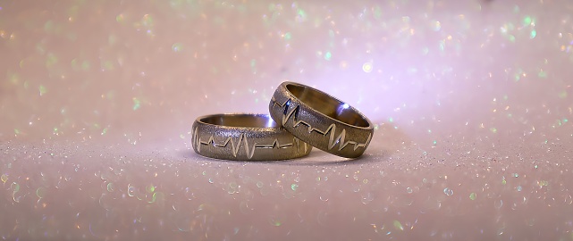 Wedding rings on shiny background