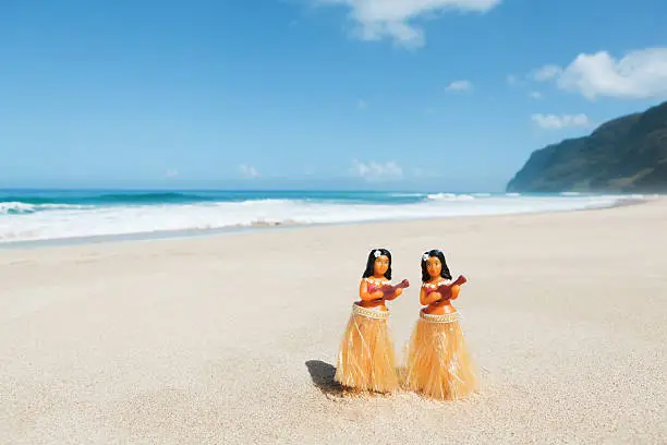 "Subject: A group of hula dancer figurines on the Beach of Hawaii.Location: Kauai, Hawaii, USA."