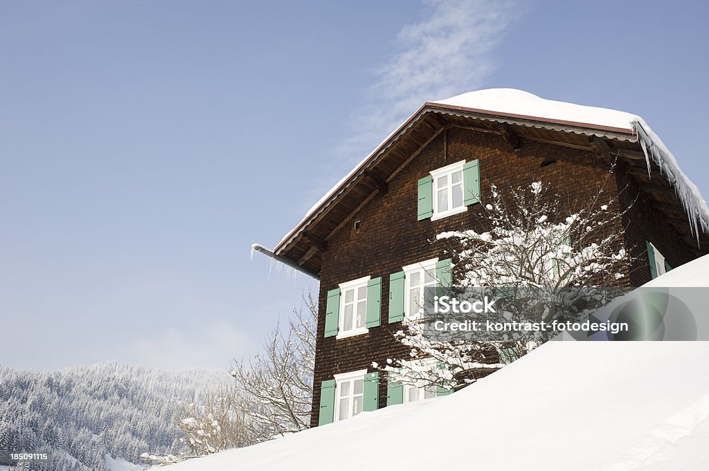 Typical wooden house, Kleinwalsertal, Riezlern, Austria "Typical wooden house in a snowcovered landscape. Located in Riezlern, Kleinwalsertal in Austria. There are some snowflakes visible." Kleinwalsertal Stock Photo