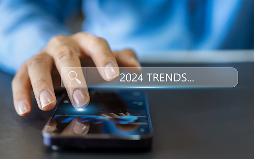 Human use smartphone searching keyword of 2024 trends, business trends, fashion trends, start up, marketing, planning, technology update, year 2024, SEO, digital marketing online