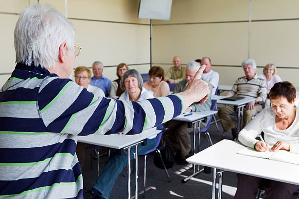 istock Senior students in education room listening lecture 185091397