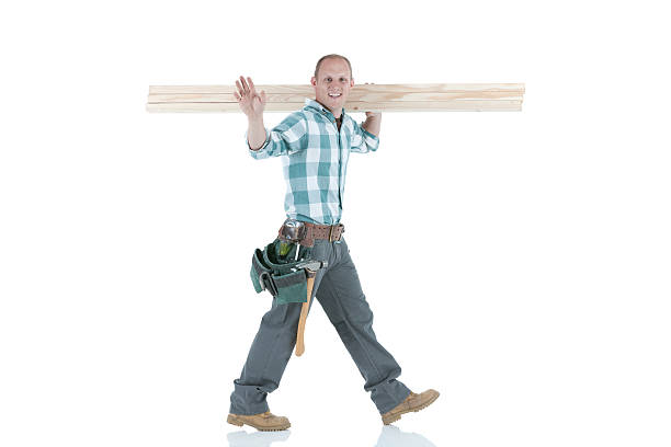 istock Happy carpenter carrying wooden planks 185091536