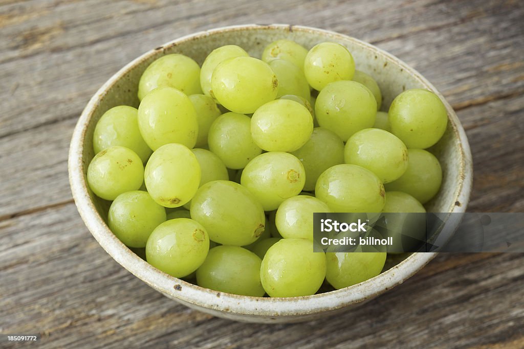Small Bowl Of Organic Green Grapes On Rustic Wood Stock Photo