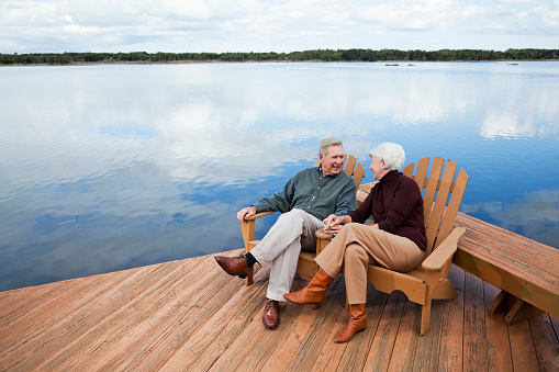 Senior couple sitting by water