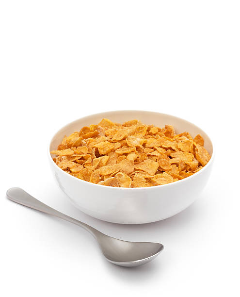 corned flakes bowl filled with corned flakes and spoon cornflakes stock pictures, royalty-free photos & images