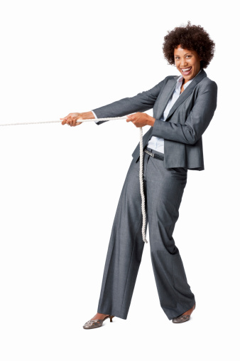 Businesswoman pulling on a rope. Vertical shot. Isolated on white.