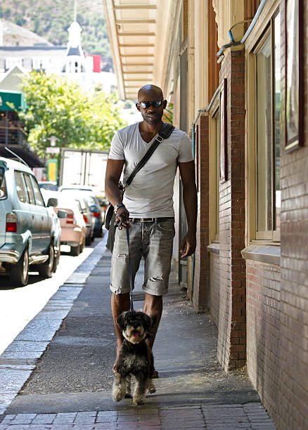 istock African metrosexual man with his dog 185092867