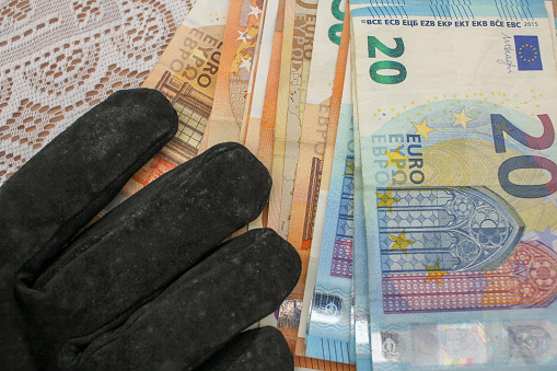 Financial Touch: Gloved Hand with Euro Bills
