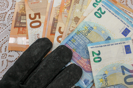Monetary Gesture: Hand in Glove with Euro Currency