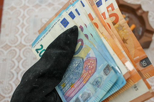 Financial Touch: Gloved Hand with Euro Bills