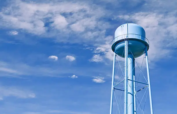 Photo of Water tower with wispy clouds in sky behind