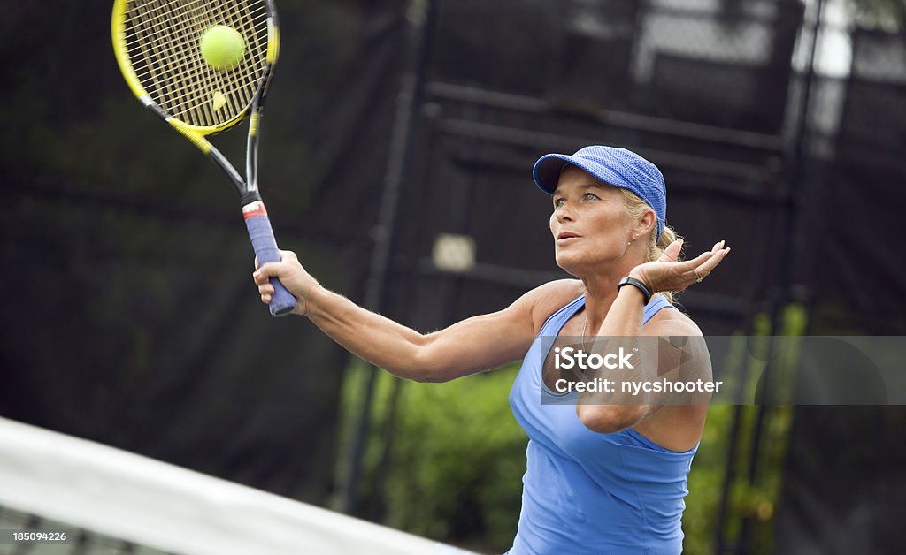 senior mujer jugando al tenis - Foto de stock de Tenis libre de derechos