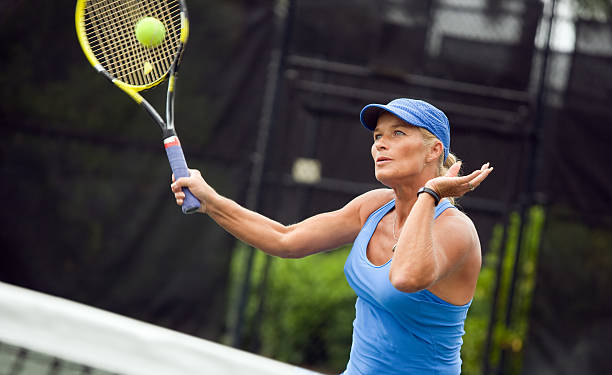 istock senior woman playing tennis 185094226