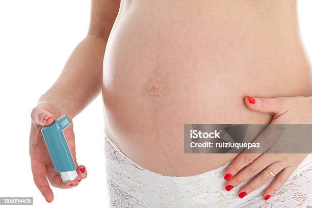A Pregnant Woman Holding An Asthma Inhaler Stock Photo - Download Image Now - Abdomen, Adult, Adults Only