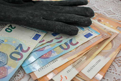 Currency Connection: Gloved Hand and Euro Banknotes