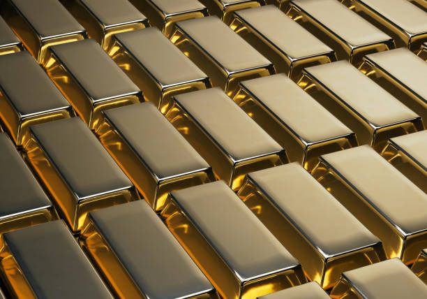 A large collection of shiny 999.9 fine gold bars arranged in neat rows on a bright background. Symbol of wealth, financial security, investment, banking, luxury economy and precious metal trading. High-resolution macro shot highlighting metallic texture, reflections and premium quality gold bullion.