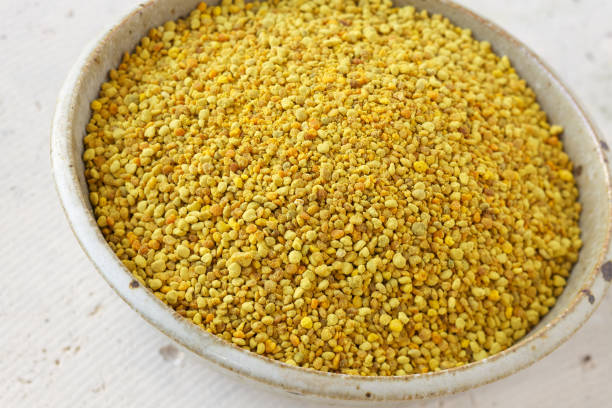 istock Natural bee pollen in ceramic bowl on concrete 185095068