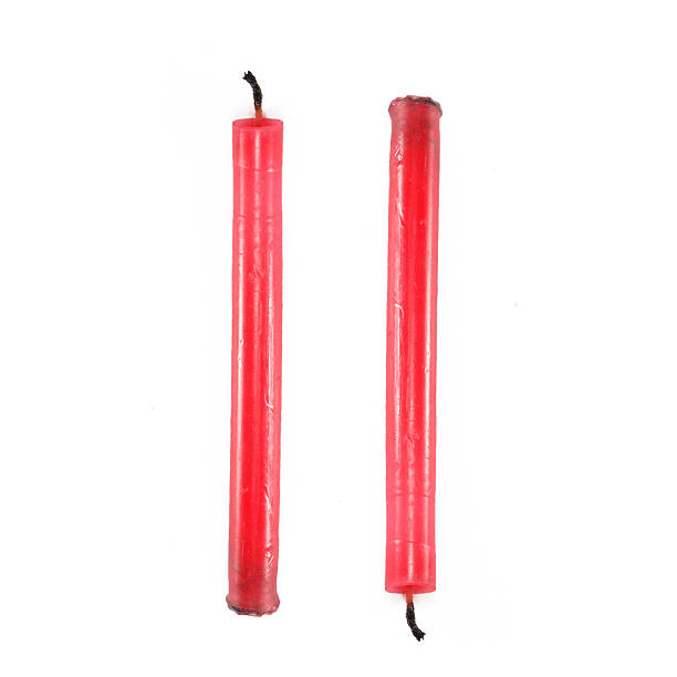 istock Two red candles in front of white background 185095075