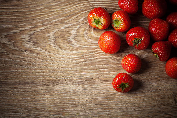 Close-up shot of Strawberry on hardwood floorMore images with strawberry: