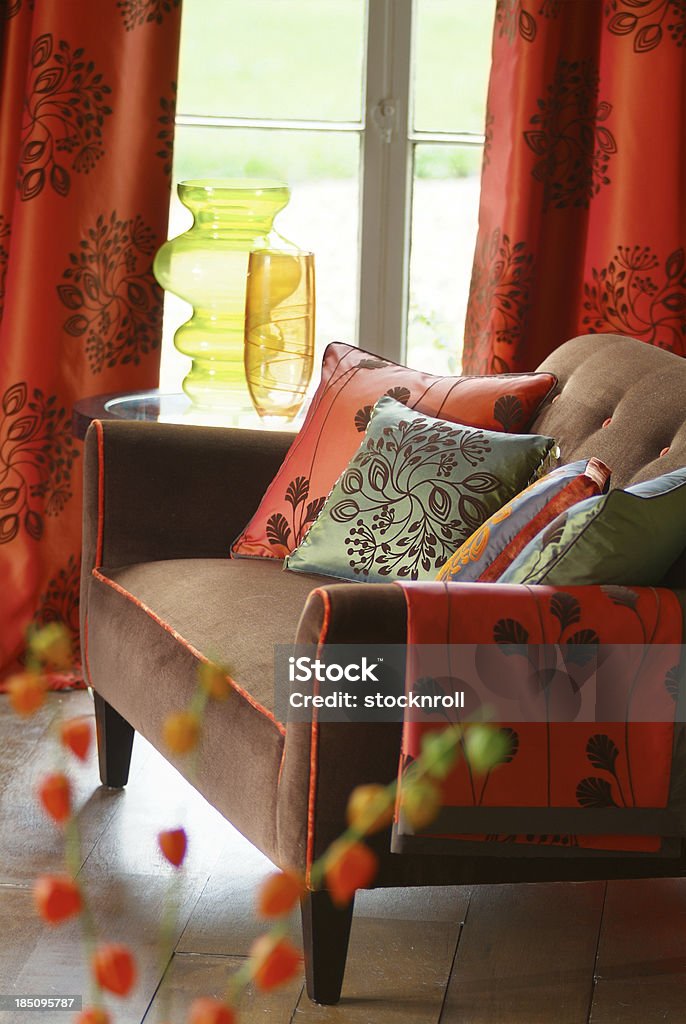 Interior of small sofa In Window with cushions Trendy small sofa with cushions n a French window Cultures Stock Photo