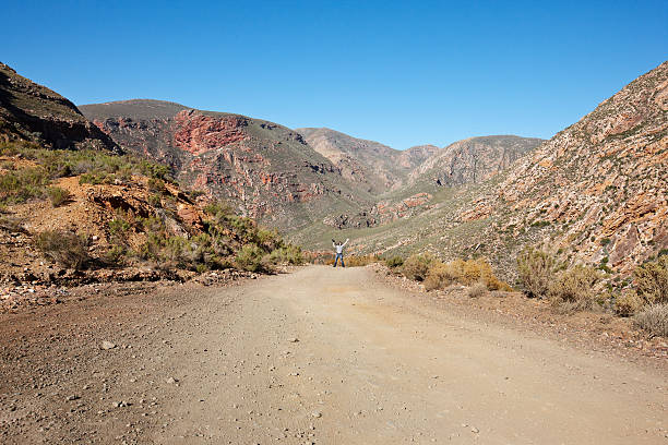 istock Man waving crazily on mountain pass dirt road 185096099