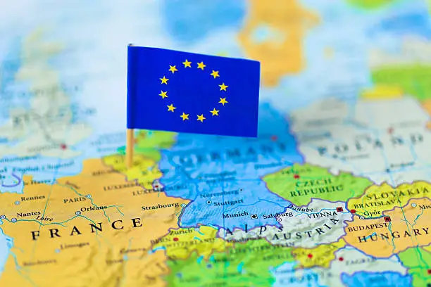 Photo of European Union flag over Europe map
