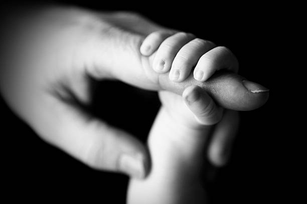 istock Newborn Hand Gripping Father's Finger 185096978