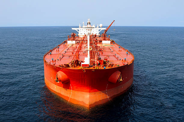 Oil Tanker "Close up aerial photo of a large oil tanker, with an oil rig in the far distance." ships bow photos stock pictures, royalty-free photos & images