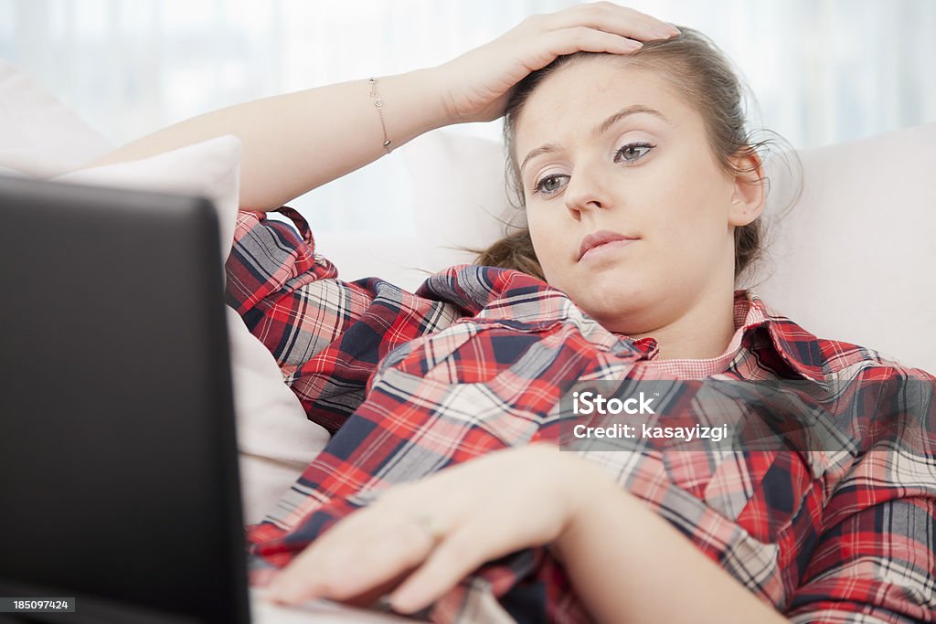 Young women bored of working Young women bored of working on notebook Adult Stock Photo
