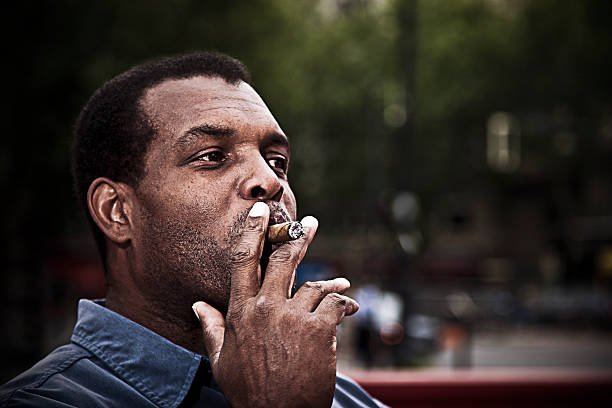 istock Adult man enjoying smoking cigar 185098366
