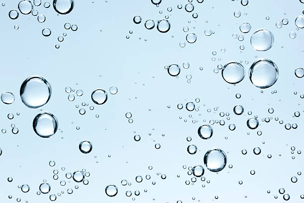 Bubbles in clear fresh water on blue background