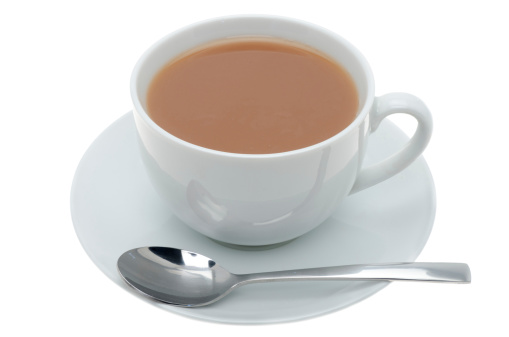 A cup of tea in white china crockery with a teaspoon - studio shot with a white background